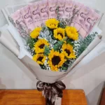 ช่อเรียงแบงค์ร้อยในช่อดอกทานตะวัน