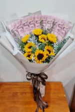 ช่อเรียงแบงค์ร้อยในช่อดอกทานตะวัน